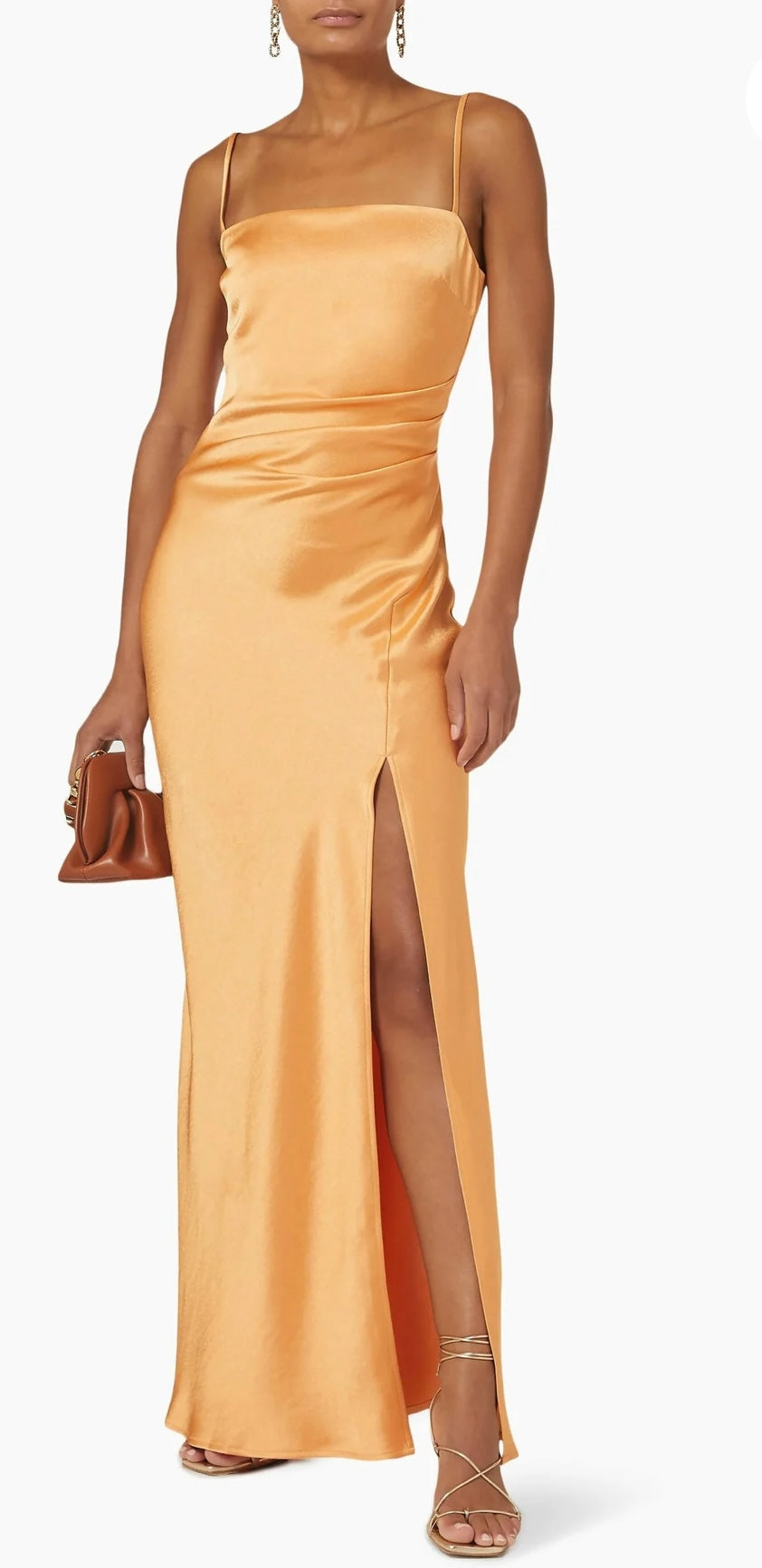 Bec & Bridge Nadia Maxi Dress in Tangerine Orange. Image shows dress with front side split and thin straps and a tan handbag aganist a white background. 