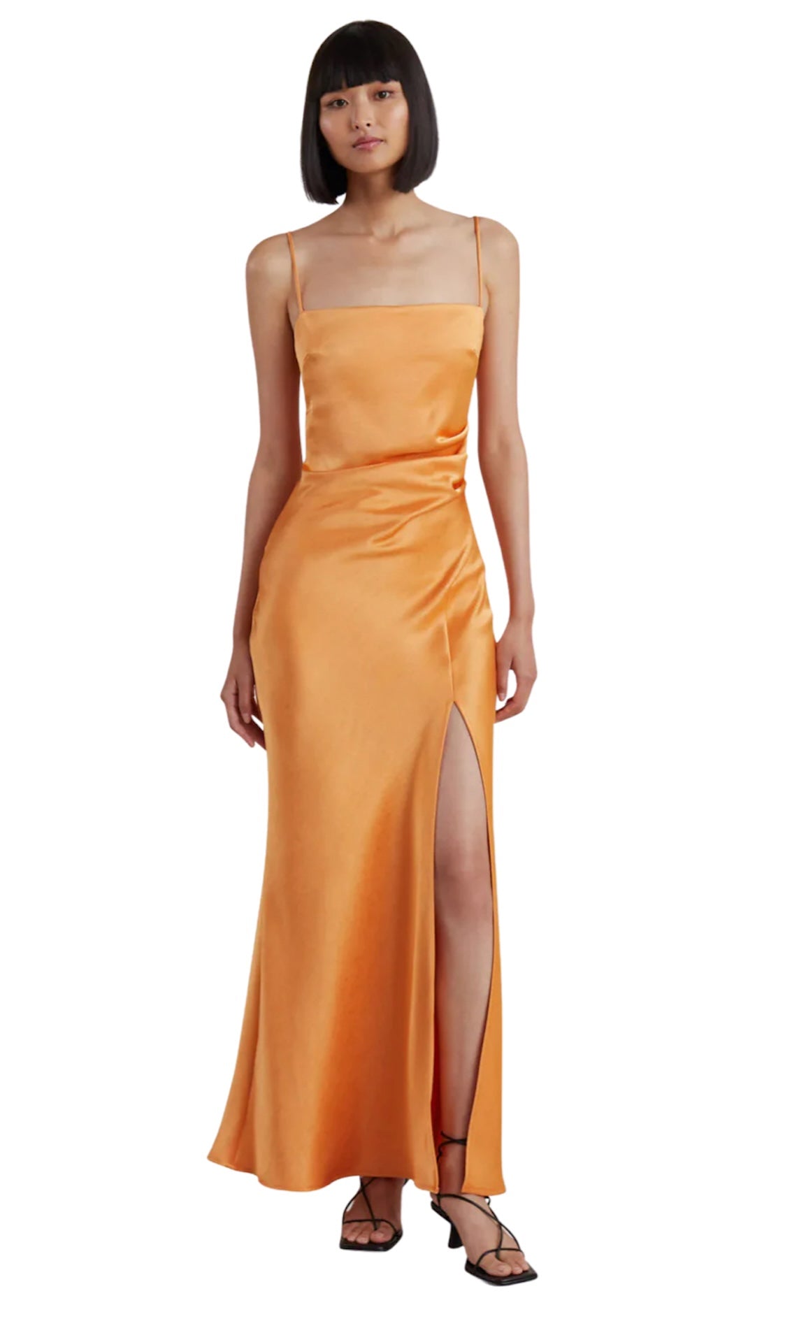 Bec and Bridge Nadia Maxi Dress in Tangerine. Model had dark hair in a short bob against a white background. 